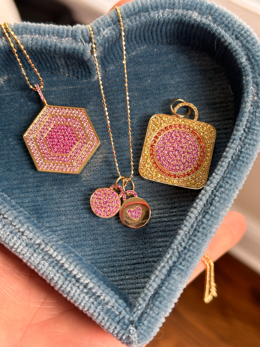 18k gold locket in pink sapphires