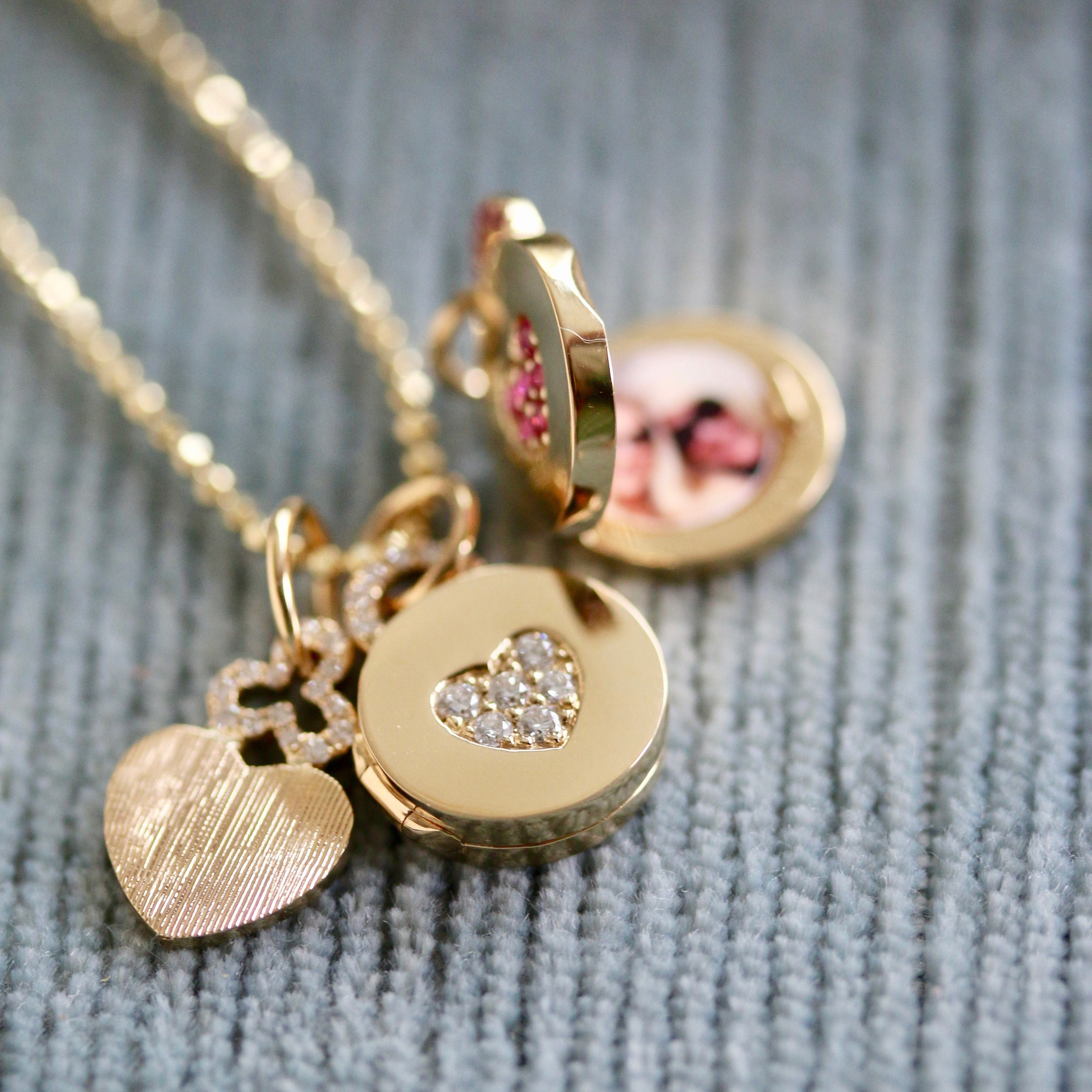 Diamond pavé heart locket necklace in 18k gold. The locket opens to allow someone to add pictures of their loved ones. A special gift! 