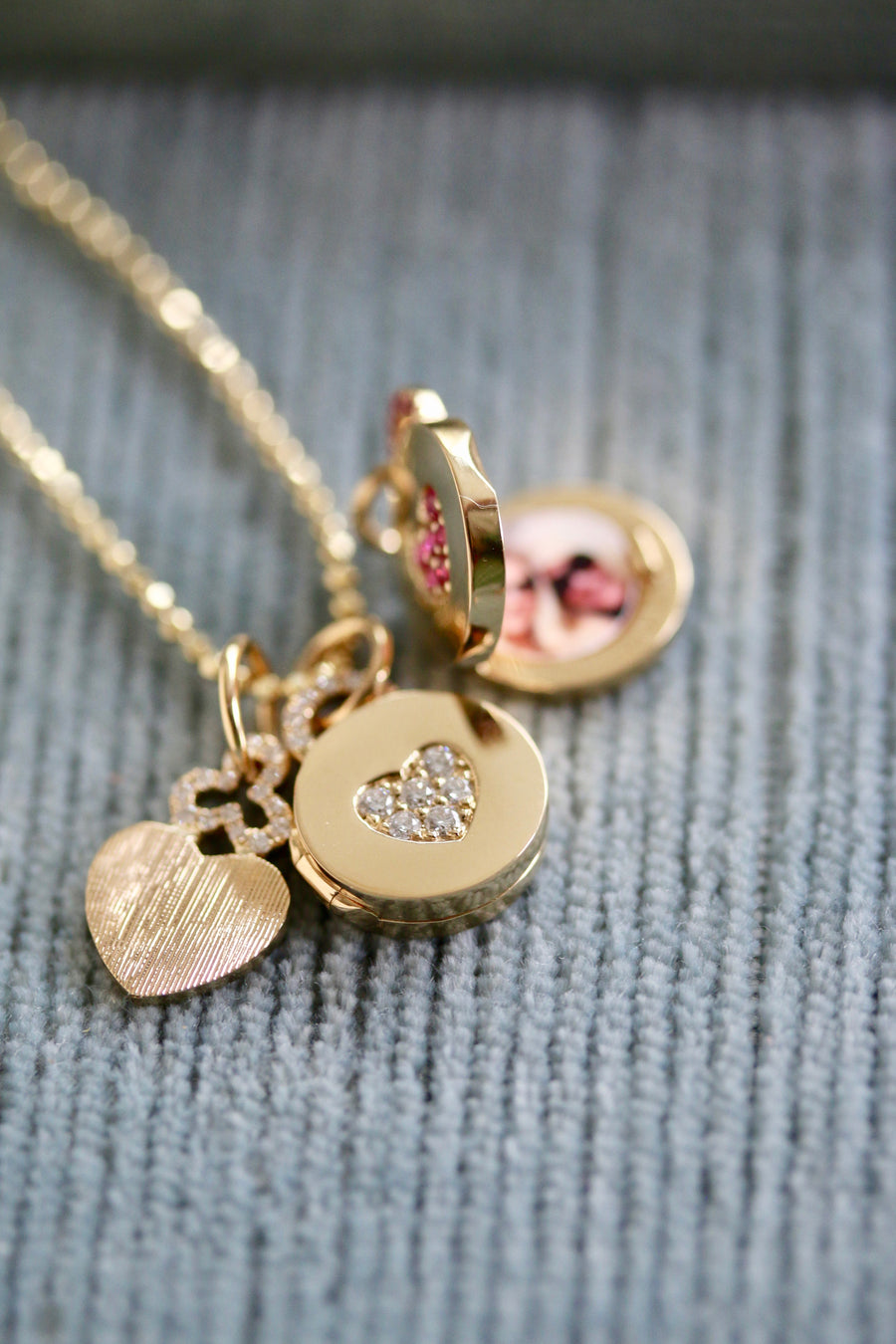 Mini locket pendant necklace featuring a heart pavé motif, radiating elegance and romance. This delicate piece showcases a charming heart-shaped locket adorned with intricate pavé detailing, adding a touch of sparkle and allure. The pavé motif accentuates the locket's timeless design, making it a symbol of love and affection that beautifully complements any ensemble. Additionally, the locket opens to allow someone to add their cherished pictures inside, adding a personal touch to this exquisite accessory.