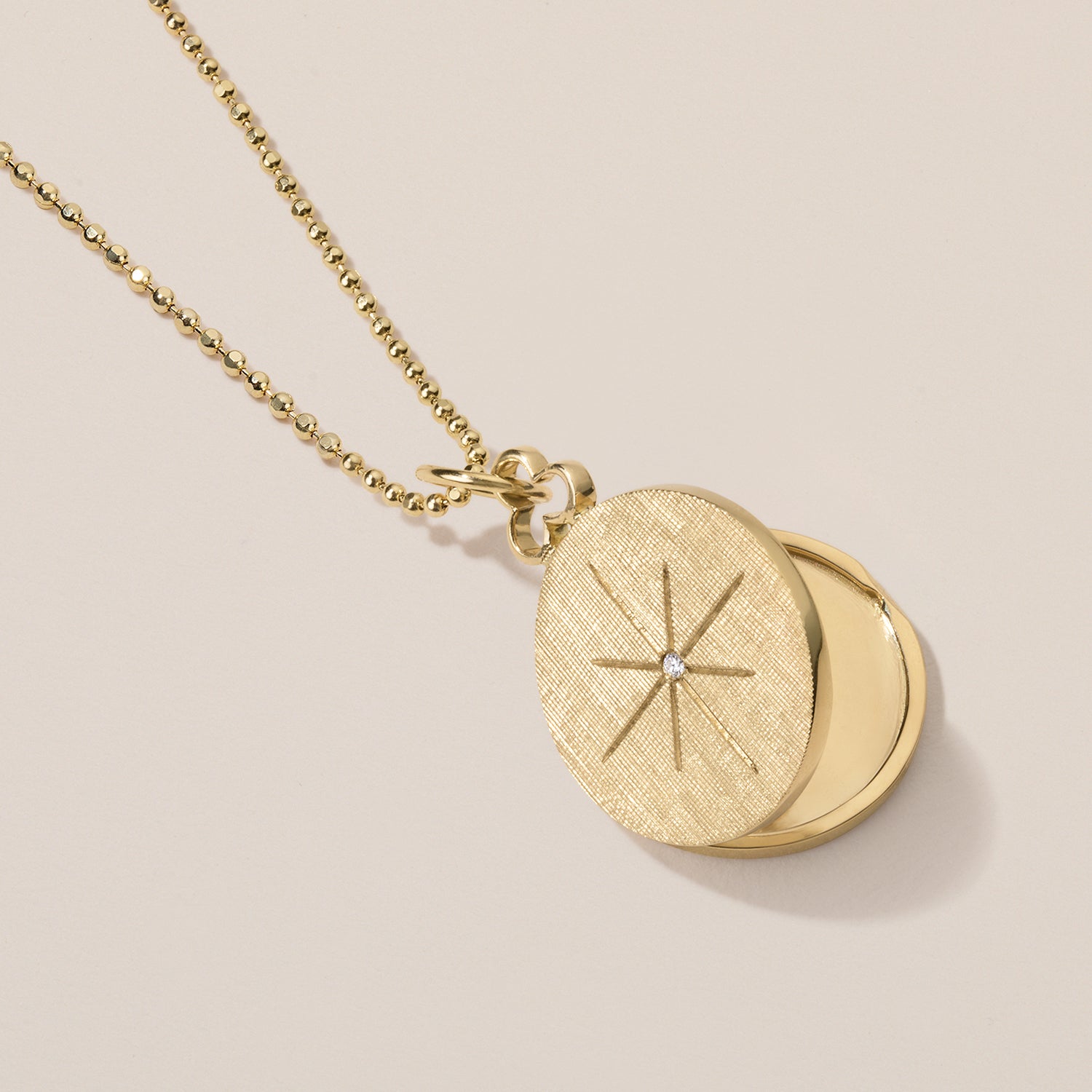 north star locket necklace in 18k gold with diamond 