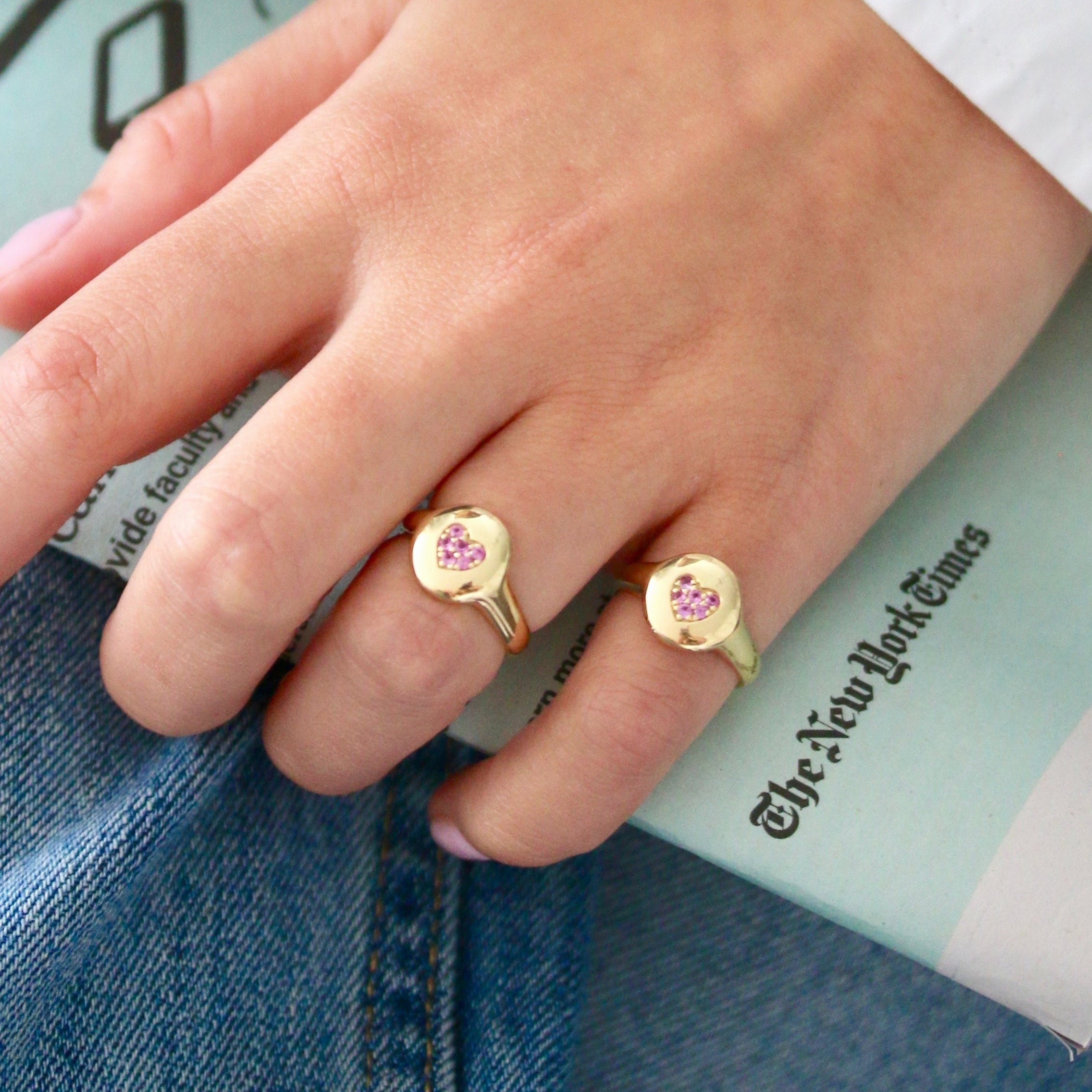 Heart ring in solid gold with a pink sapphire pavé heart design
