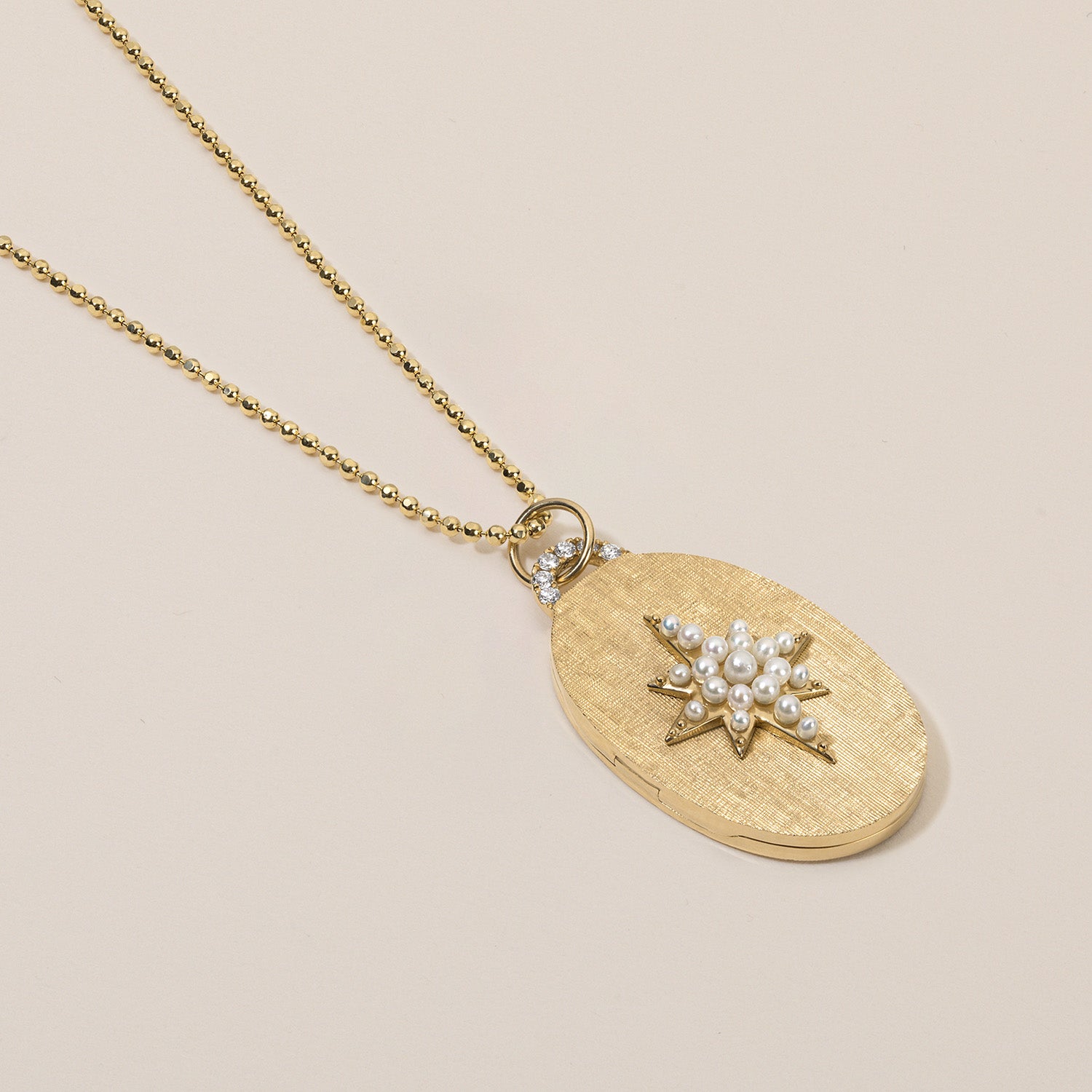 pearl north star oval locket necklace with diamond arch in florentine finish
