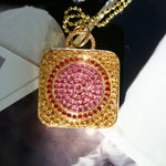 Square locket crafted in 18k gold, adorned with beautiful pink sapphires. This stunning piece features a contemporary design with intricate detailing and vibrant pink sapphire accents. The pink sapphires add a pop of color and elegance to the square locket, creating a unique and eye-catching accessory.