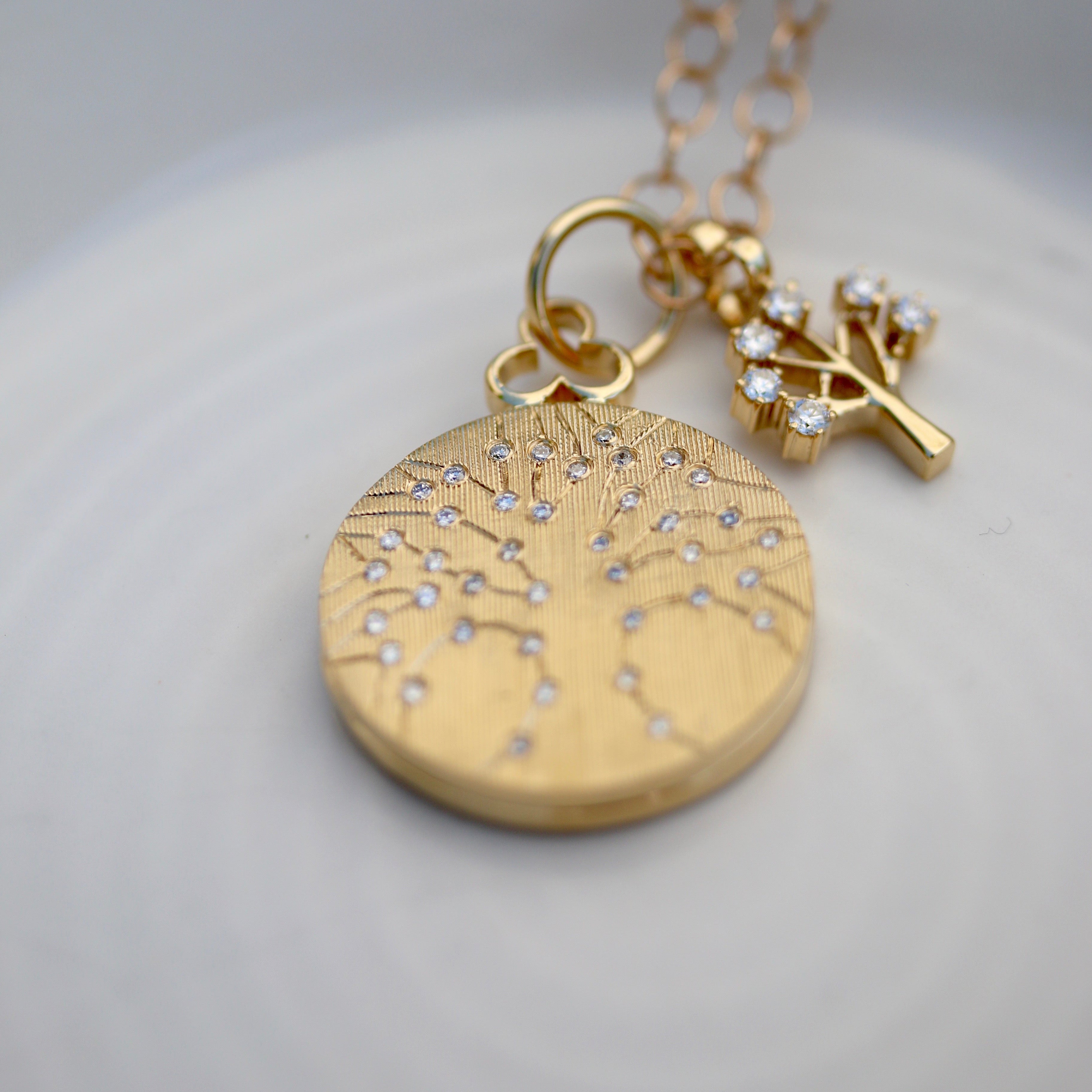 Tree of Life locket necklace crafted in luxurious 18k gold, symbolizing growth and vitality. This exquisite piece features intricate detailing of the Tree of Life motif, adding elegance and charm to any ensemble. Perfect for those seeking timeless beauty and symbolism in their jewelry collection.